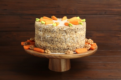 Photo of Stand with delicious carrot cake on wooden background