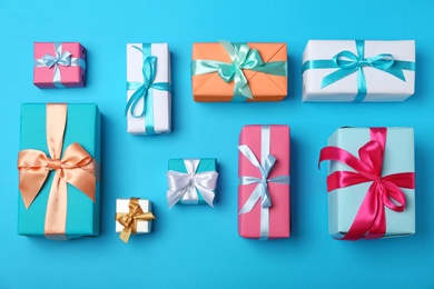 Photo of Flat lay composition with beautiful gift boxes on color background