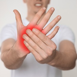 Image of Man suffering from rheumatism on light background, closeup