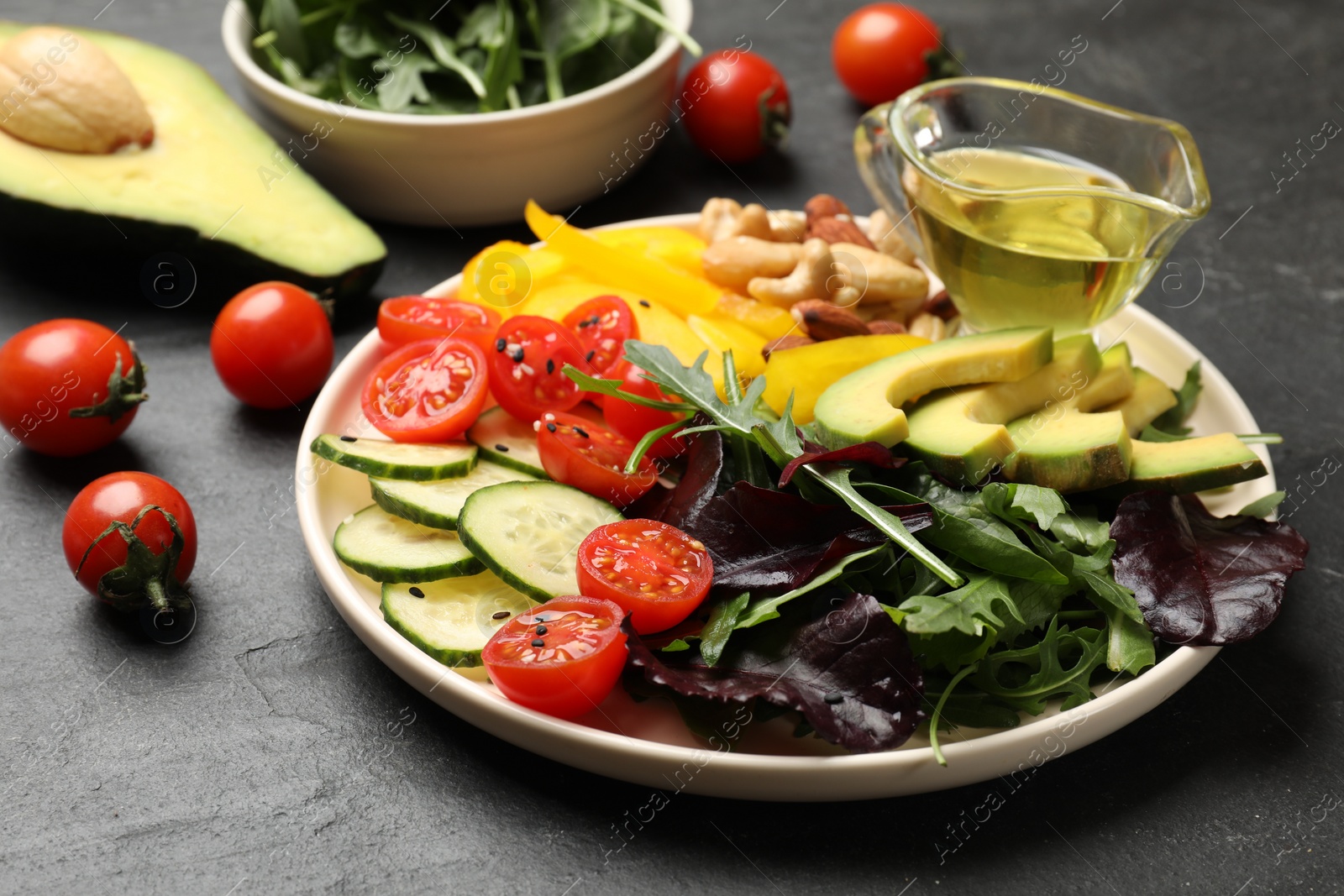 Photo of Balanced diet and vegetarian foods. Plate with different delicious products on black table, closeup