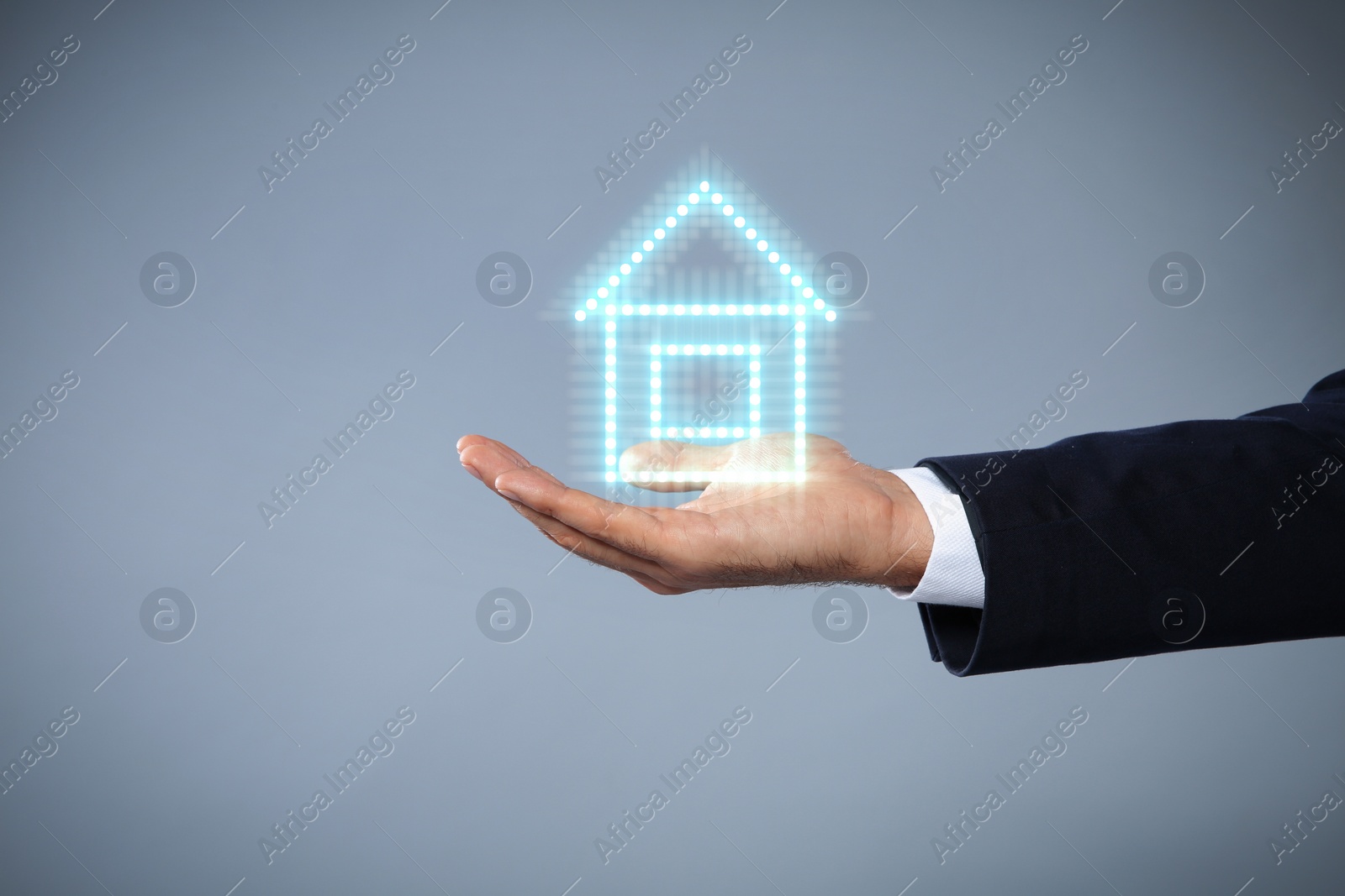 Image of Mortgage rate. Man holding illustration of house on grey background, closeup. Space for text