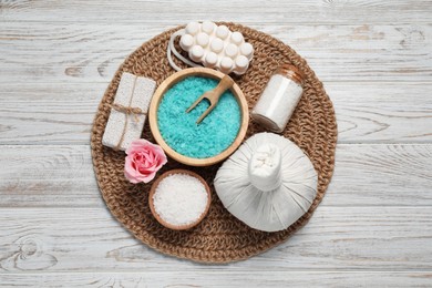 Photo of Composition of herbal bag and spa products on white wooden table, top view