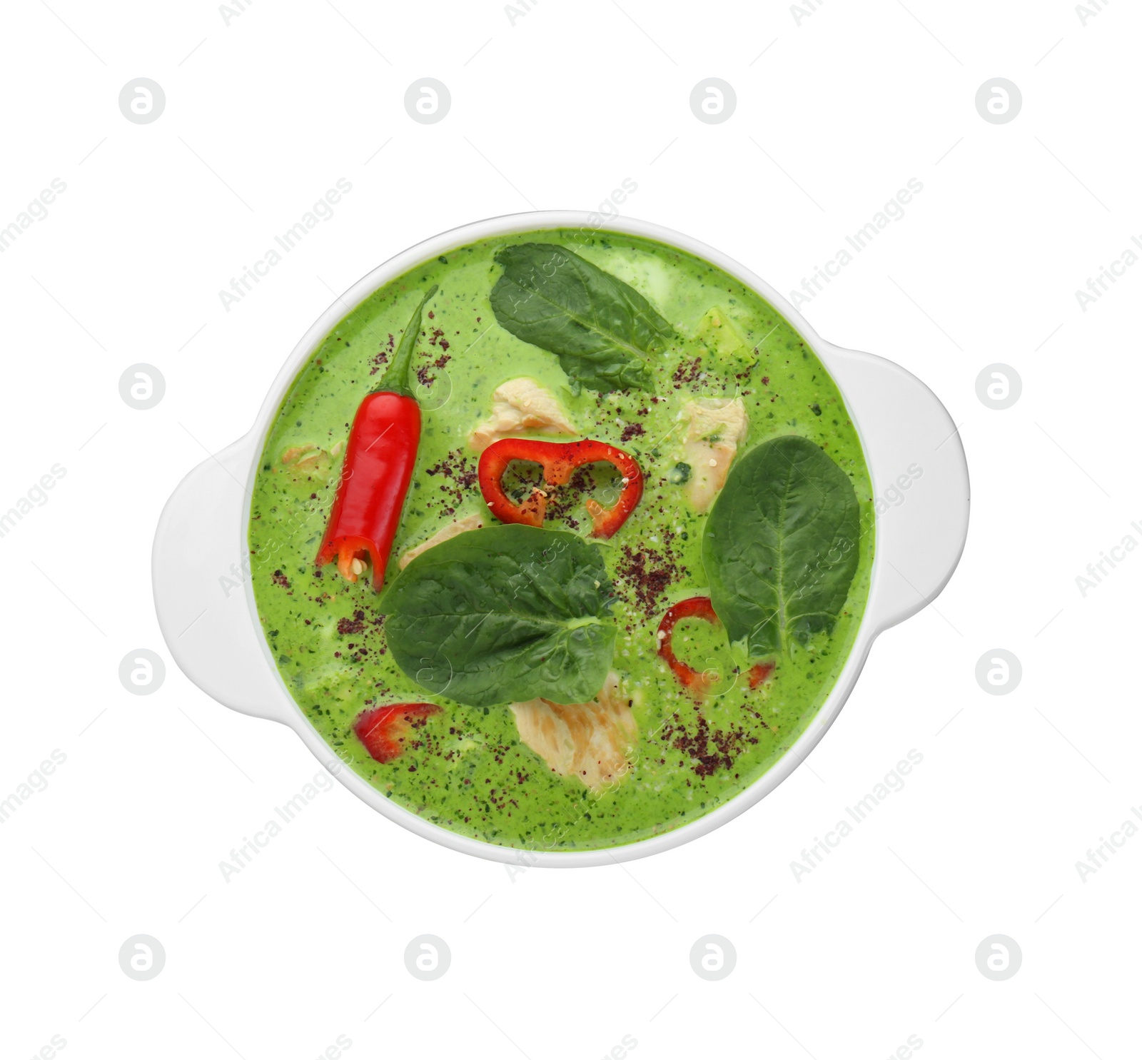 Photo of Saucepan of delicious green curry soup with chicken isolated on white, top view