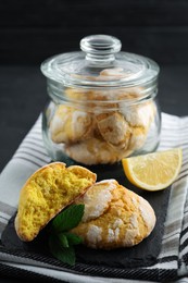 Photo of Glass jar with delicious lemon cookies on table