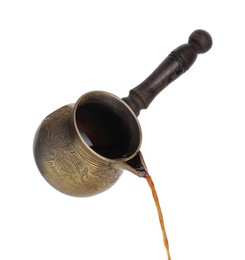Photo of Turkish coffee. Pouring brewed beverage from cezve on white background