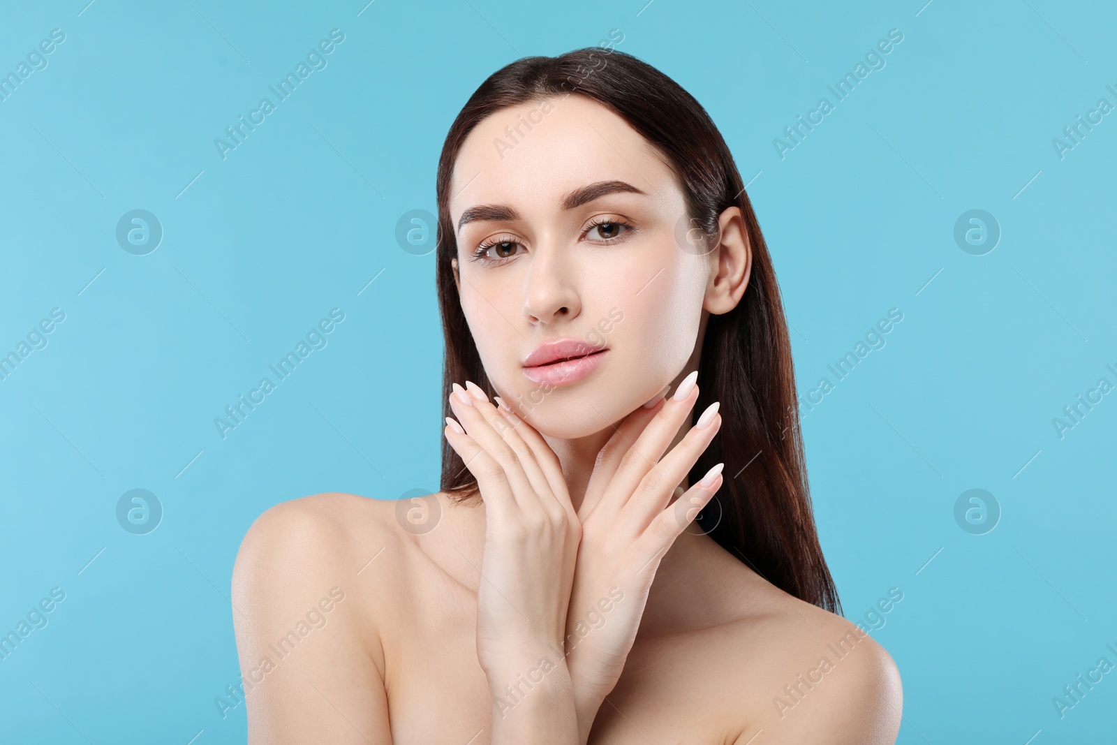 Photo of Portrait of beautiful young woman on light blue background