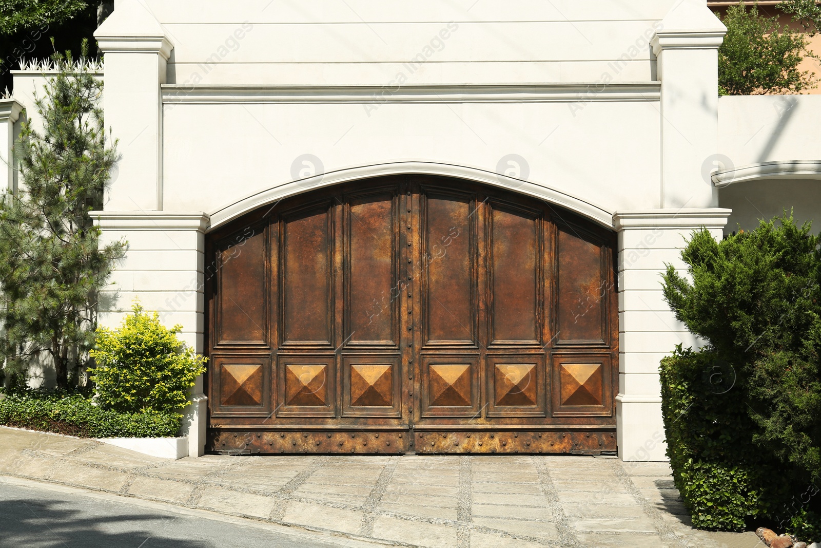 Photo of Beautiful old metal gate and white wall outdoors