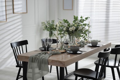 Photo of Festive table setting with beautiful tableware and decor indoors