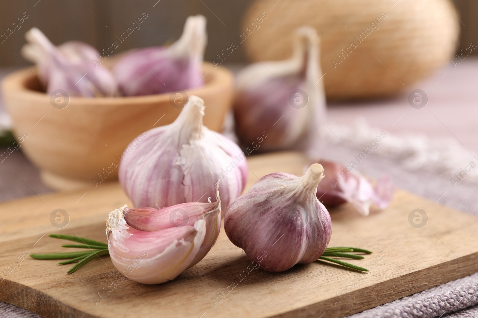 Photo of Bulbs and cloves of fresh garlic on table, closeup