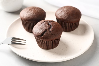 Delicious chocolate cupcakes on white table, closeup