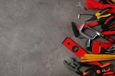 Photo of Flat lay composition with repair tools on grey stone table, space for text