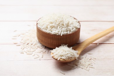 Photo of Uncooked raw basmati rice on white wooden table