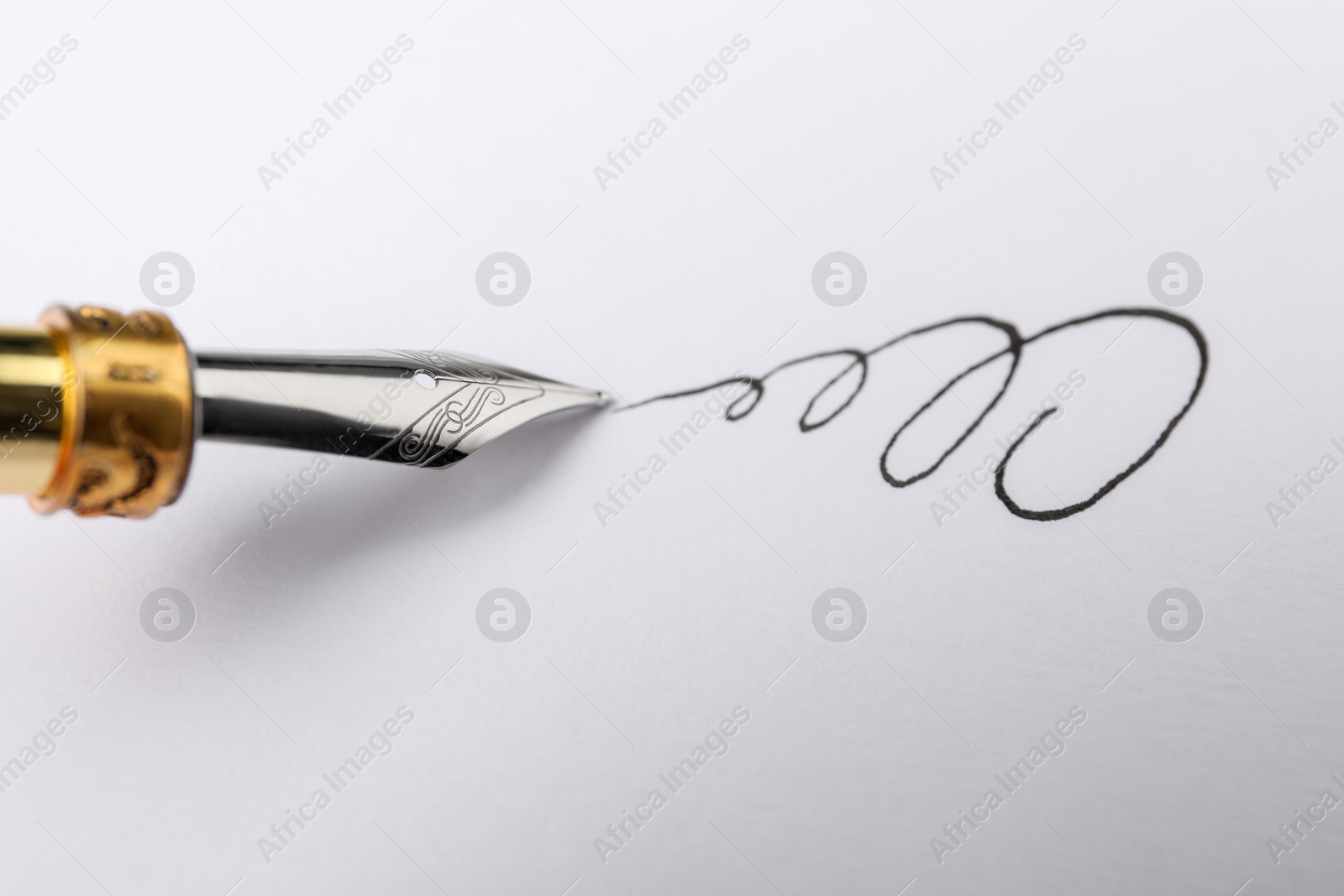 Photo of Signing on sheet of paper with fountain pen, closeup