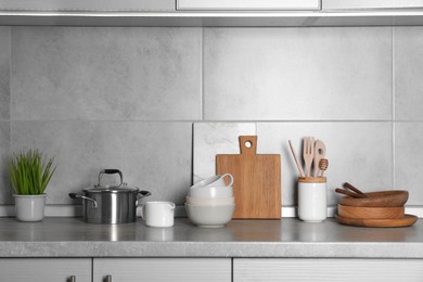 Cooking utensils and other kitchenware on grey countertop