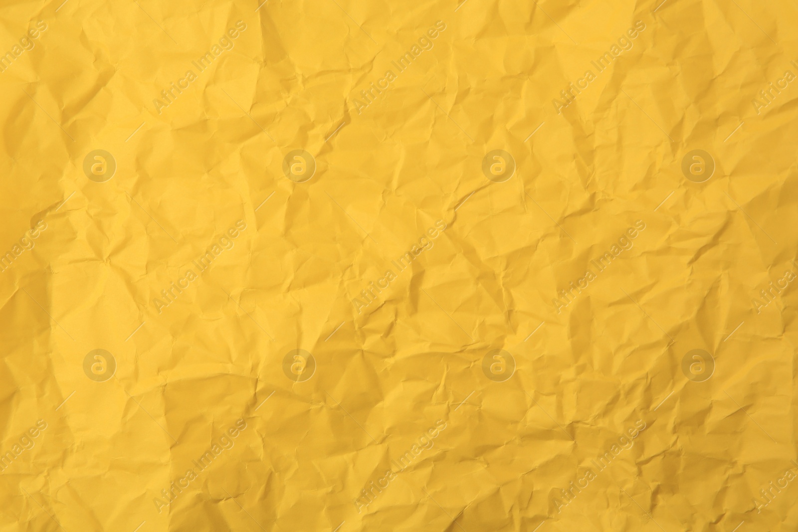 Photo of Sheet of crumpled orange paper as background, top view