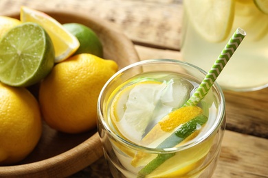 Photo of Natural lemonade with lime in glass on table, closeup