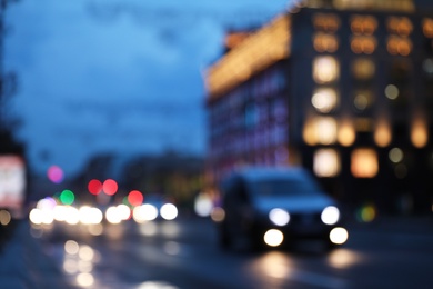 Photo of Blurred view of modern city at evening. Bokeh effect