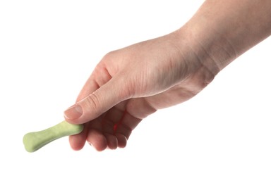 Photo of Woman holding bone shaped dog cookie on white background, closeup