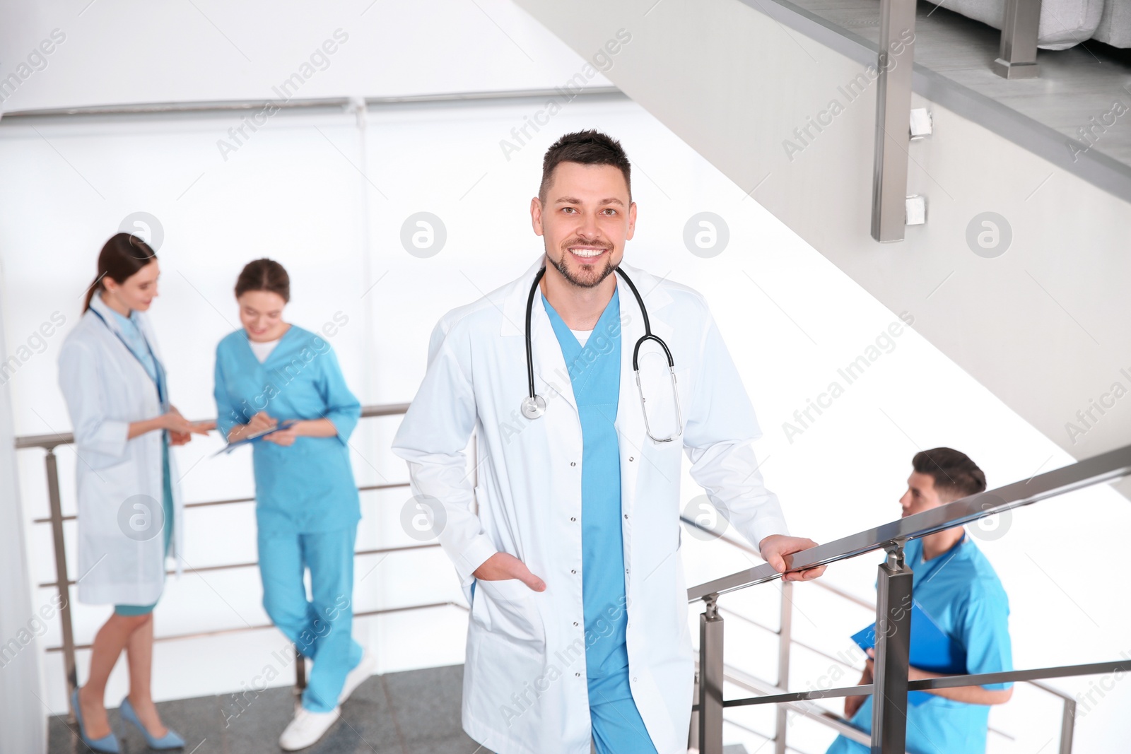 Photo of Male doctor going upstairs in modern clinic