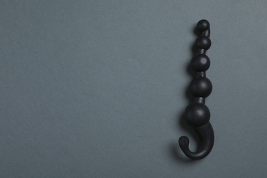 Photo of Black anal ball beads on dark background, top view with space for text. Sex toy