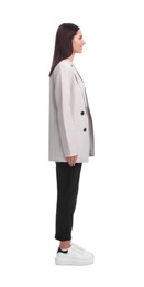 Photo of Young businesswoman in suit standing on white background