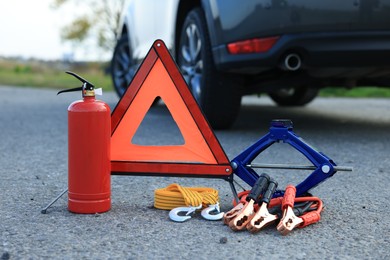 Photo of Emergency warning triangle and car safety equipment outdoors