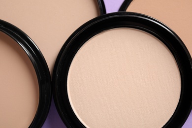 Photo of Various shades of makeup face powder as background, closeup