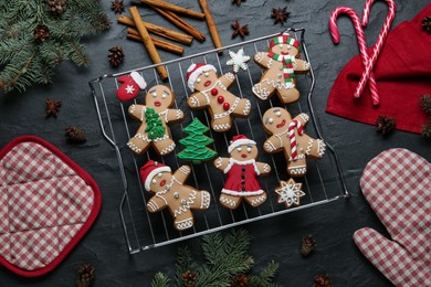 Photo of Flat lay composition with delicious Christmas cookies on black table