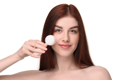 Washing face. Young woman with cleansing brush on white background