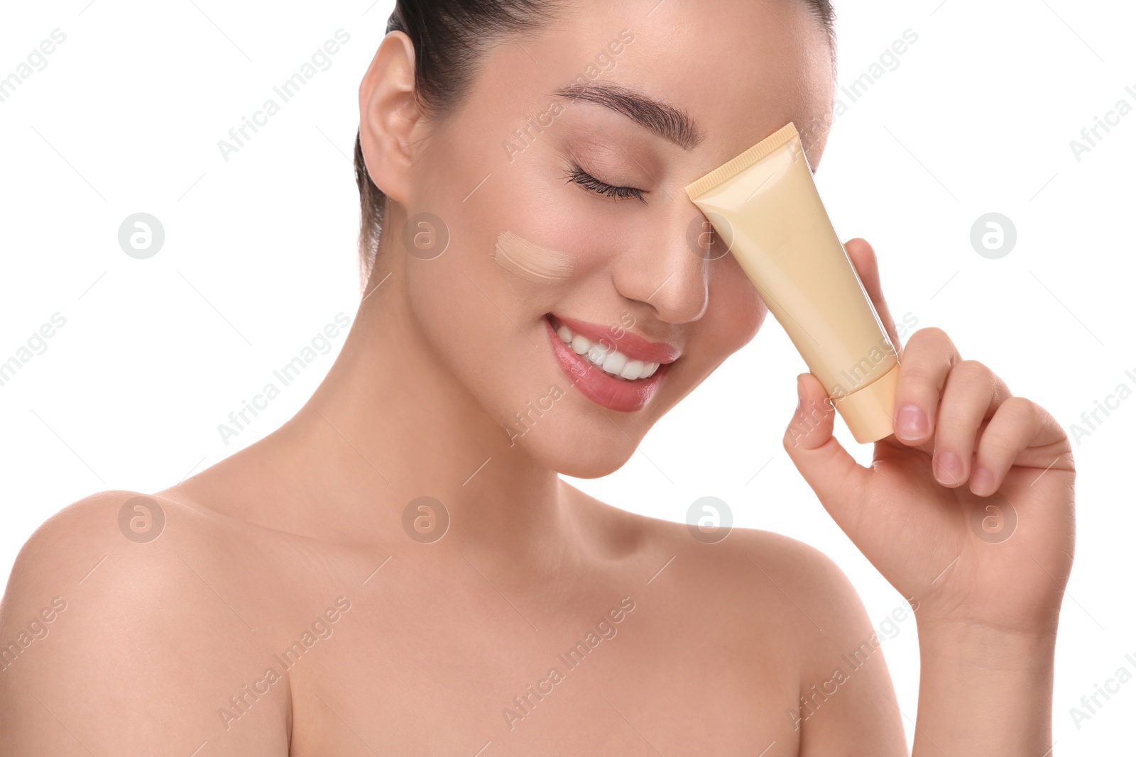 Photo of Woman holding tube of foundation on white background