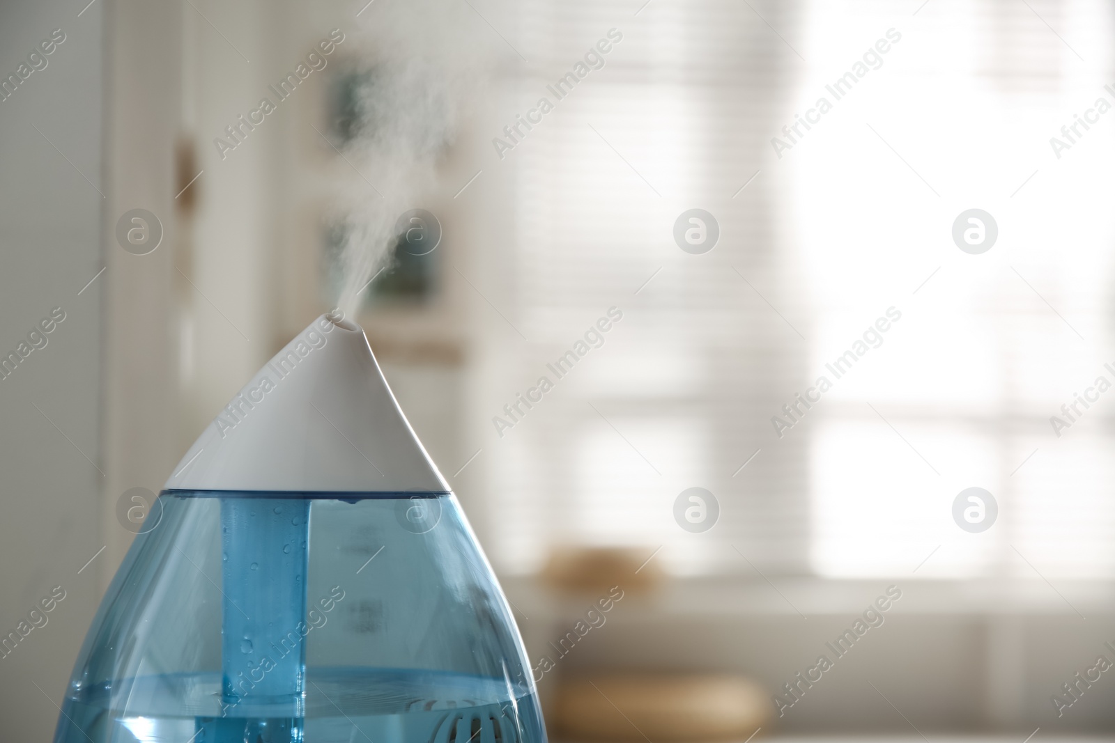 Photo of Modern humidifier indoors, closeup. Space for text