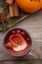 Photo of Aromatic mulled wine in glass cup on table, top view