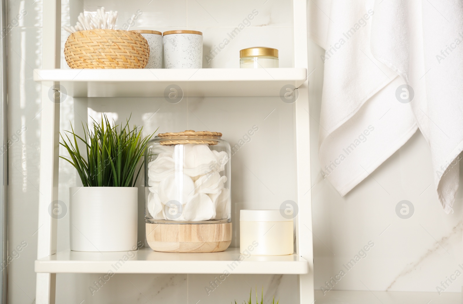 Photo of Shelving unit with toiletries in bathroom interior