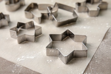 Cutters for homemade Christmas cookies on table