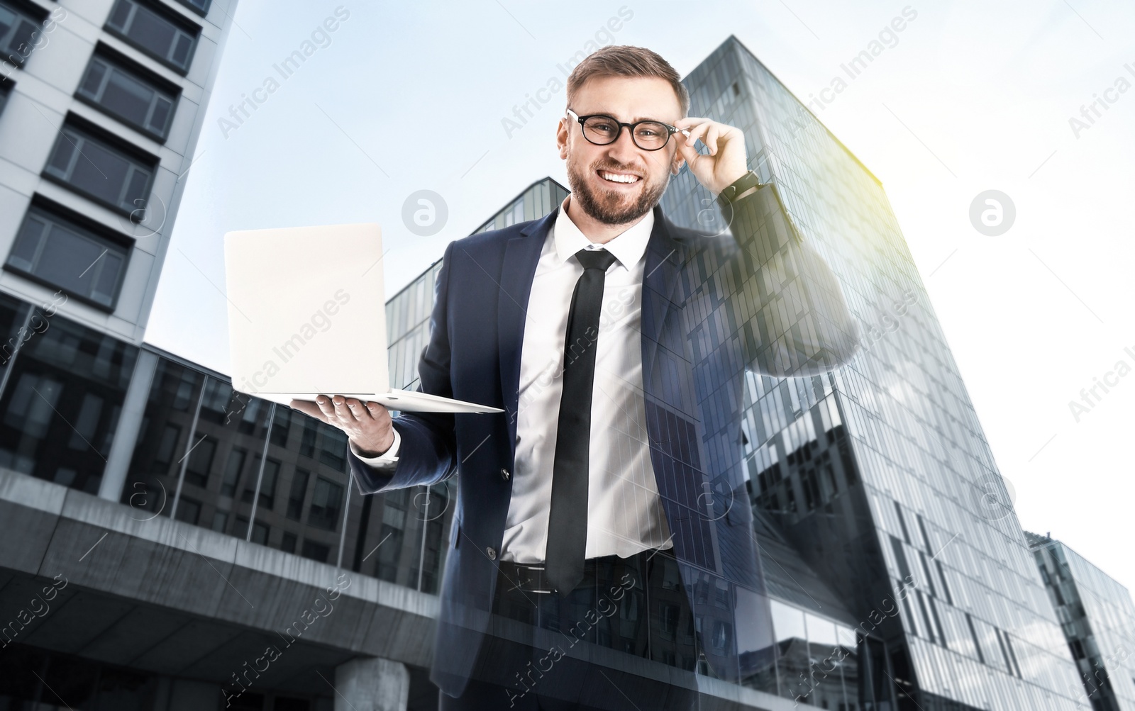 Image of Double exposure of architect working with laptop and buildings