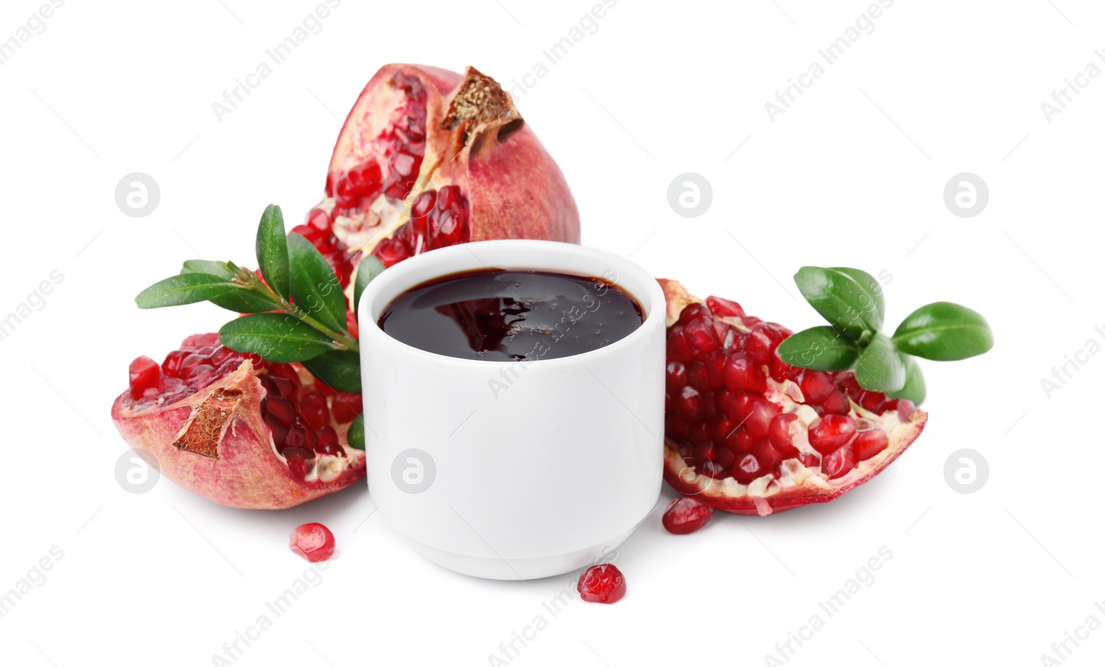 Photo of Tasty pomegranate sauce, fruits and branches isolated on white