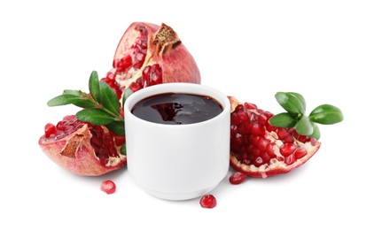 Photo of Tasty pomegranate sauce, fruits and branches isolated on white