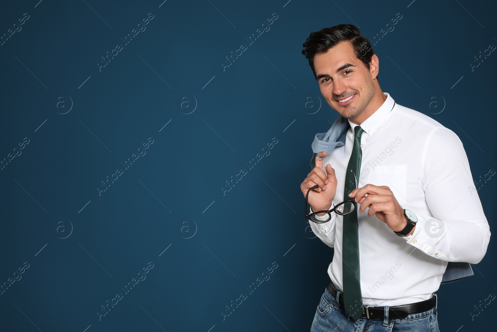 Photo of Portrait of handsome young businessman on blue background