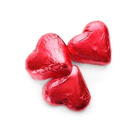 Photo of Heart shaped chocolate candies in red foil on white background, top view