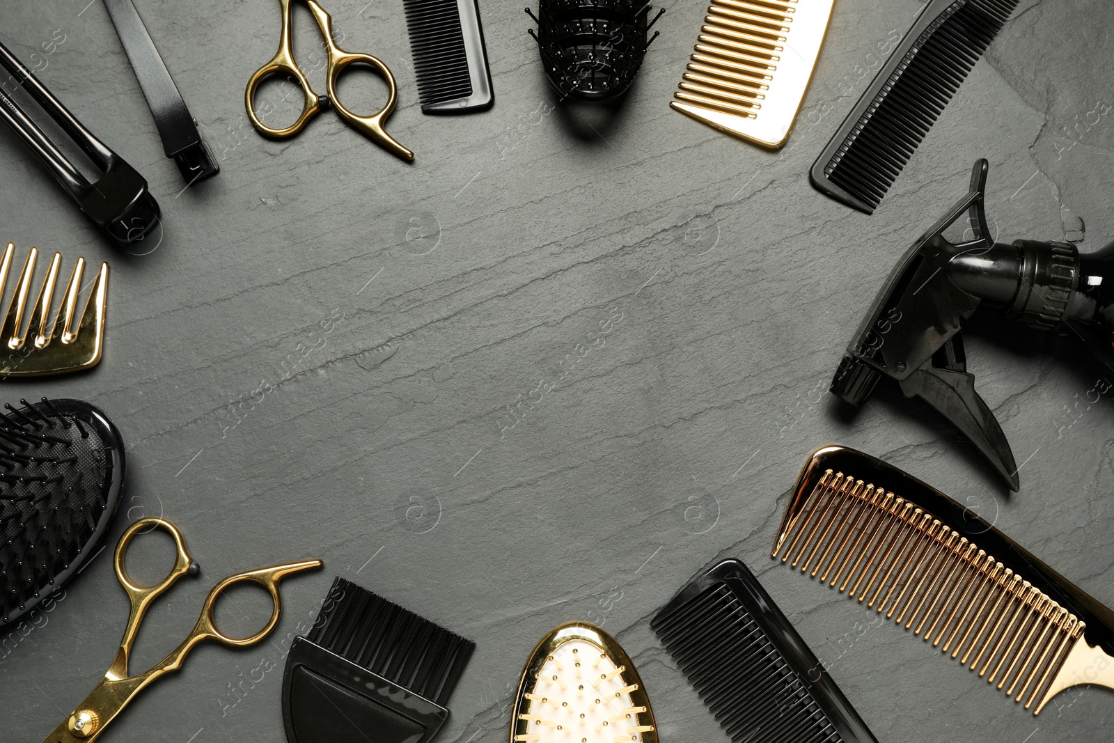 Photo of Frame of hairdressing tools on grey textured background, flat lay. Space for text