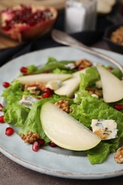 Photo of Delicious pear salad on dark table, closeup