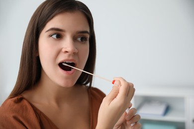 Photo of Woman taking sample for DNA test indoors