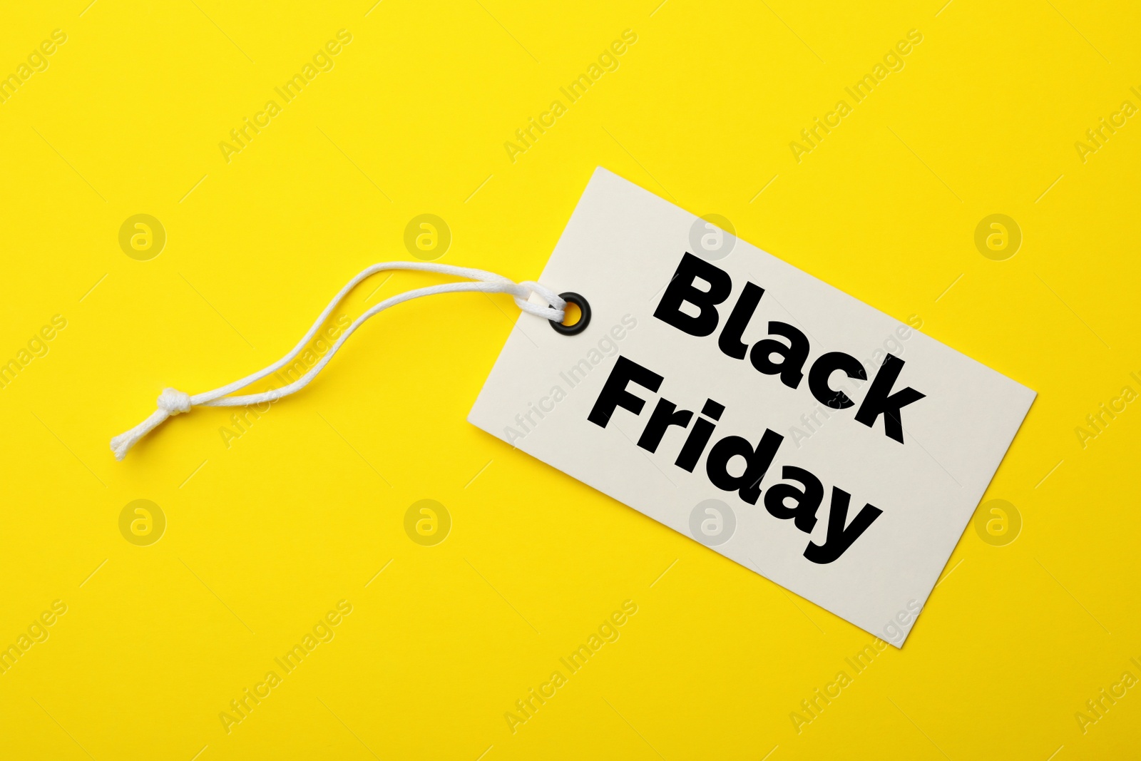 Image of Tag with text BLACK FRIDAY on yellow background, top view