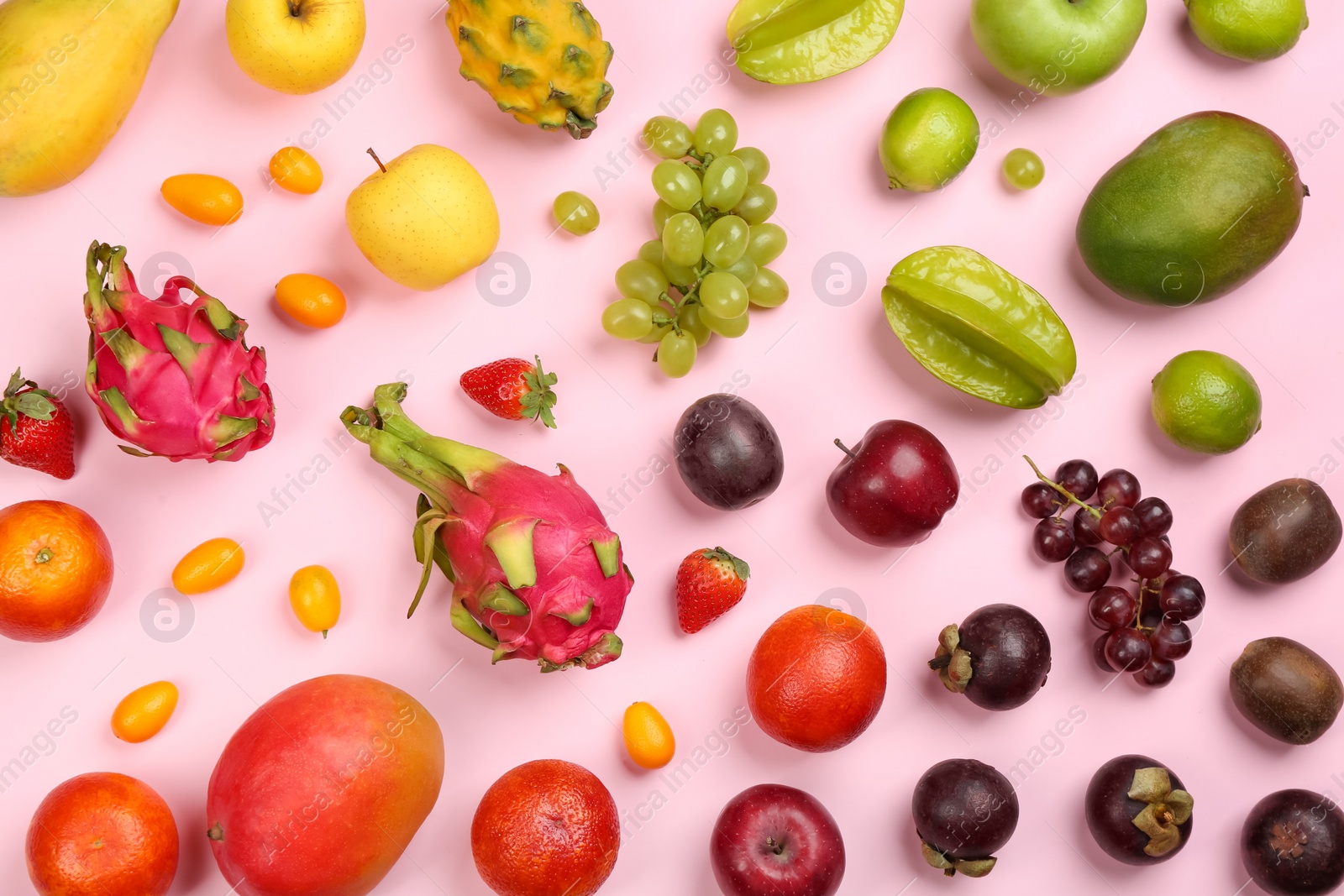 Photo of Assortment of fresh exotic fruits on pink background, flat lay