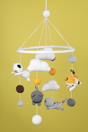 Cute baby crib mobile on yellow background