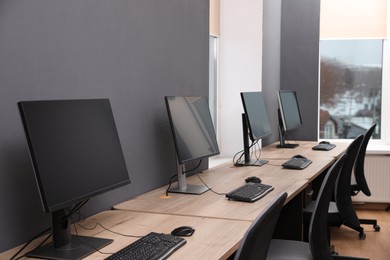 Photo of Many modern computers in open space office