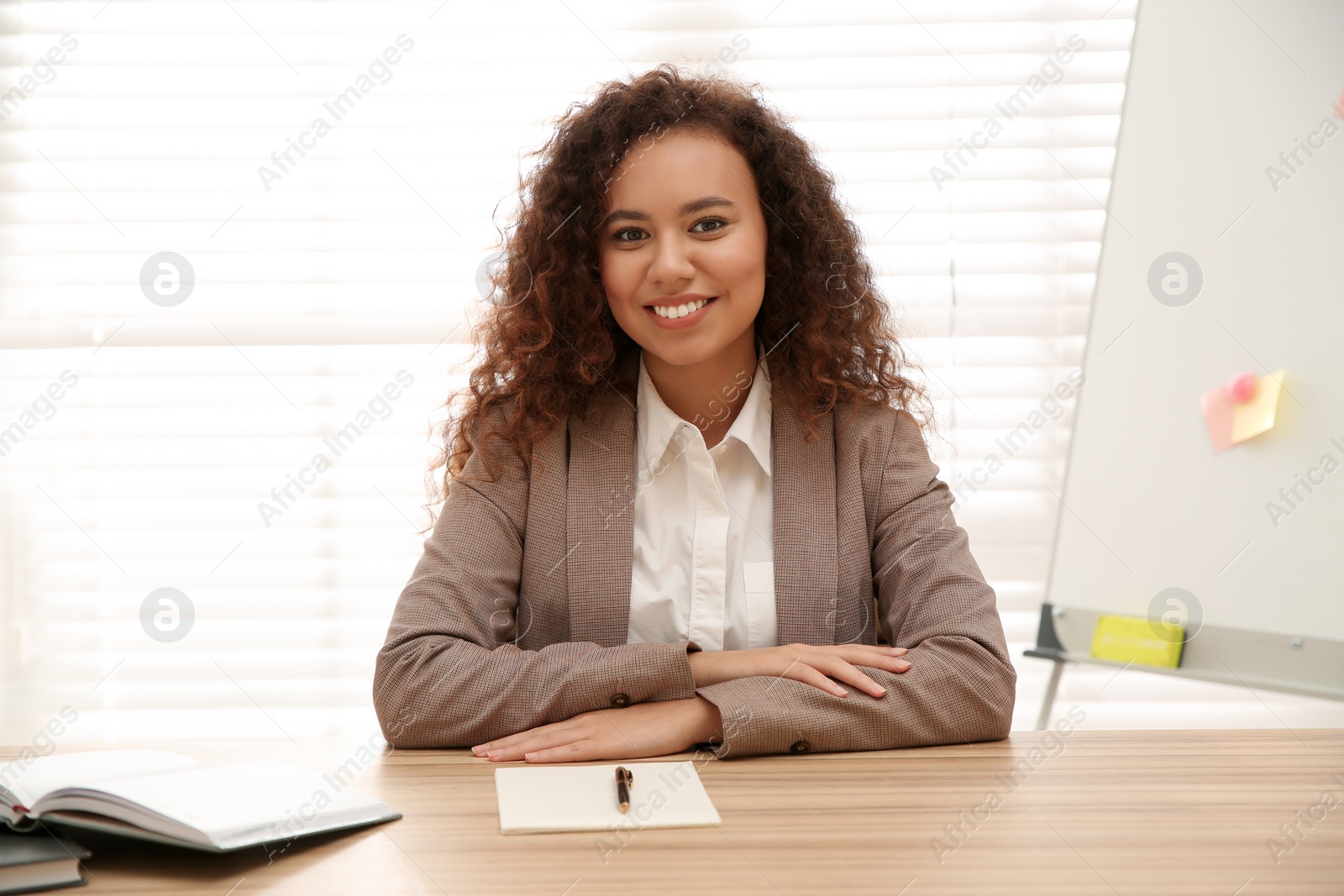 Photo of Happy African-American woman using video chat in office, view from web camera