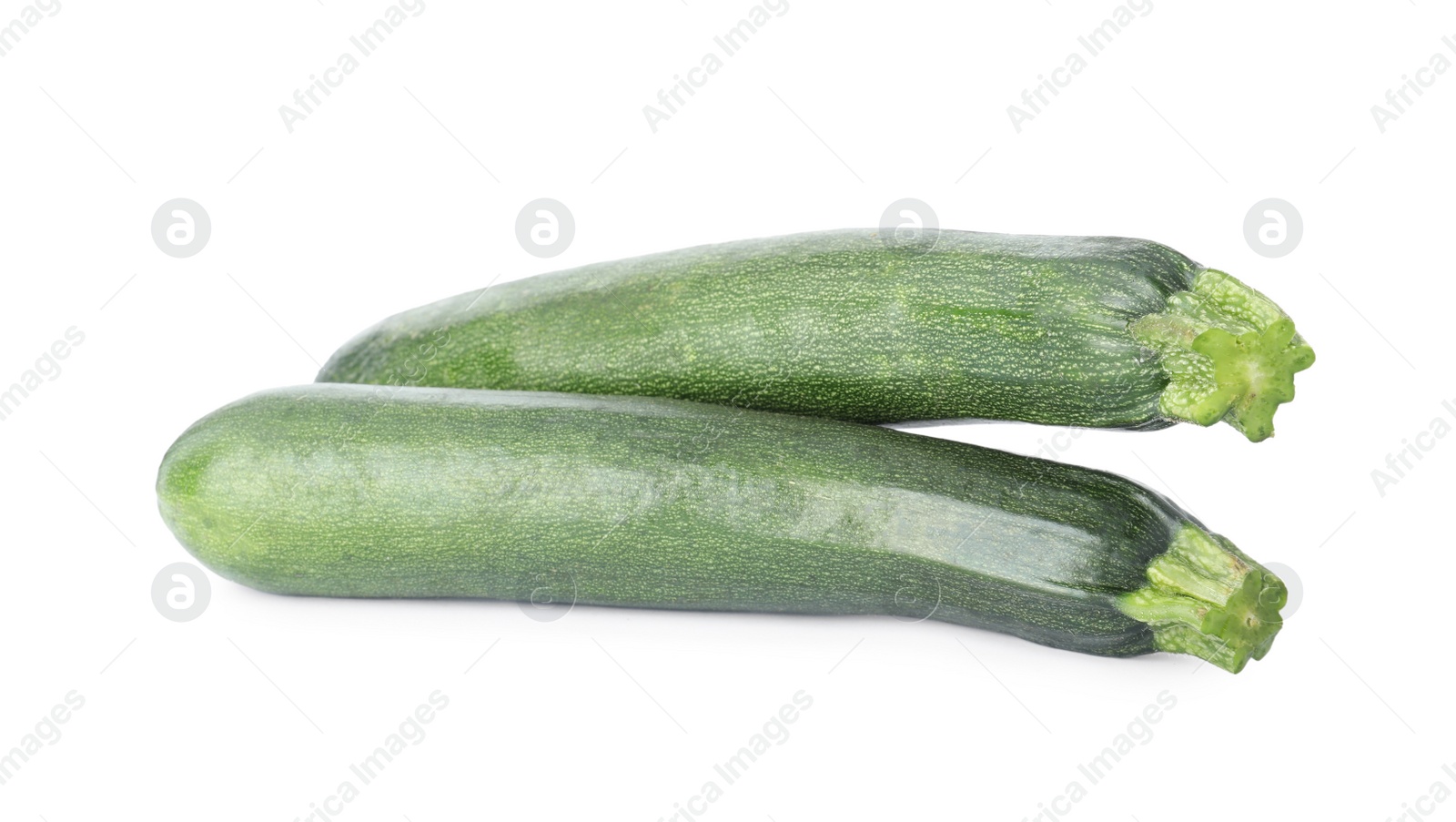 Photo of Raw green ripe zucchinis isolated on white