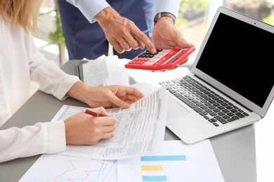 Photo of Tax accountants working with documents at table