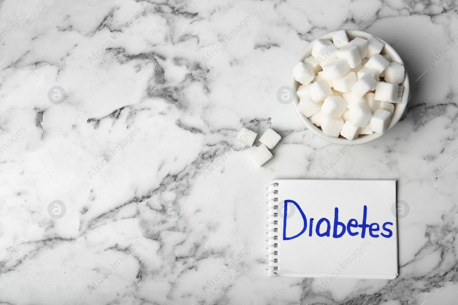 Photo of Flat lay composition with word DIABETES and sugar on marble background